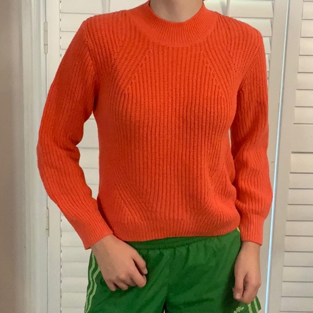Old Navy L (10-12) Girl’s Orange Sweater.  Would fit a small woman.
